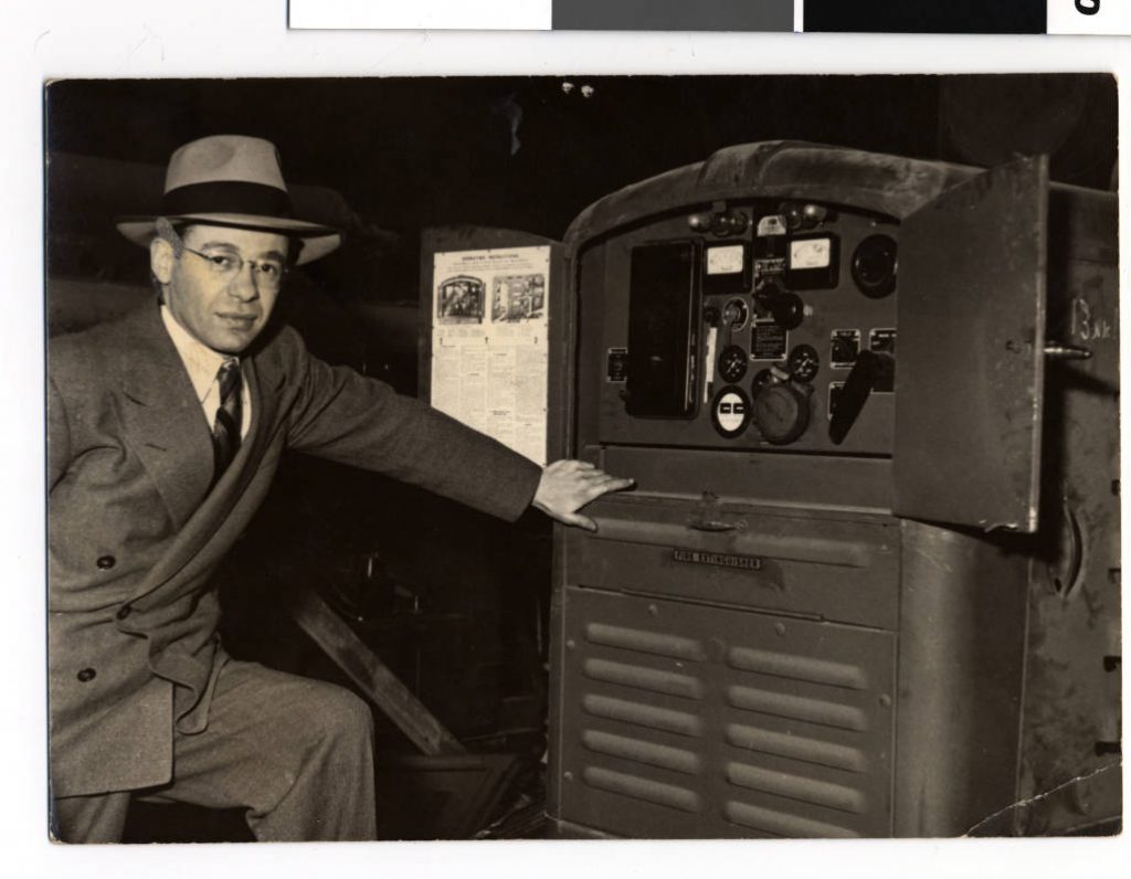 Sam Ziff in front of a generator to be sent to a kibbutz, St. Paul