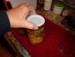 Tattler Canning-Lifting jar gently to check seal